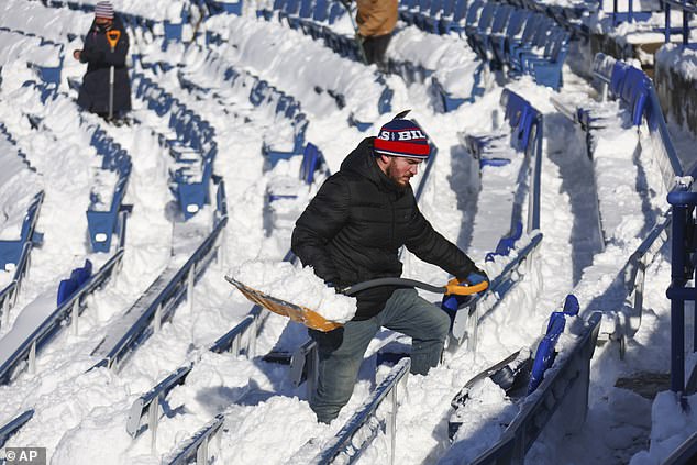 Before a postponed game against the Steelers, fans helped clear snow from the stands