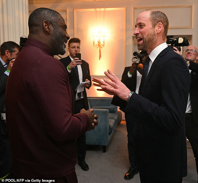 Britain's Prince William, Prince of Wales, talks to actor and activist Idris Elba