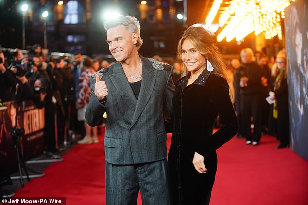 Robbie gave a thumbs up to photographers before heading to the premiere of his film