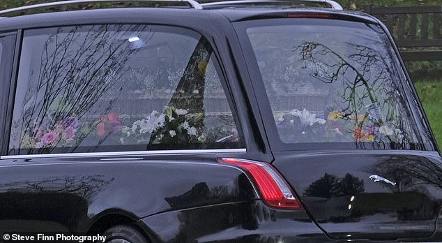 Flowers on the coffin outside Vinters Park Crematorium prior to the funeral