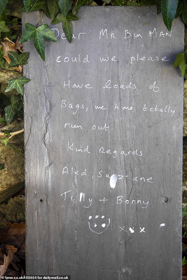 At the garage there is a slate sign, which may have been left by the previous owners, asking 'Mr Binman' for 'lots of bags'