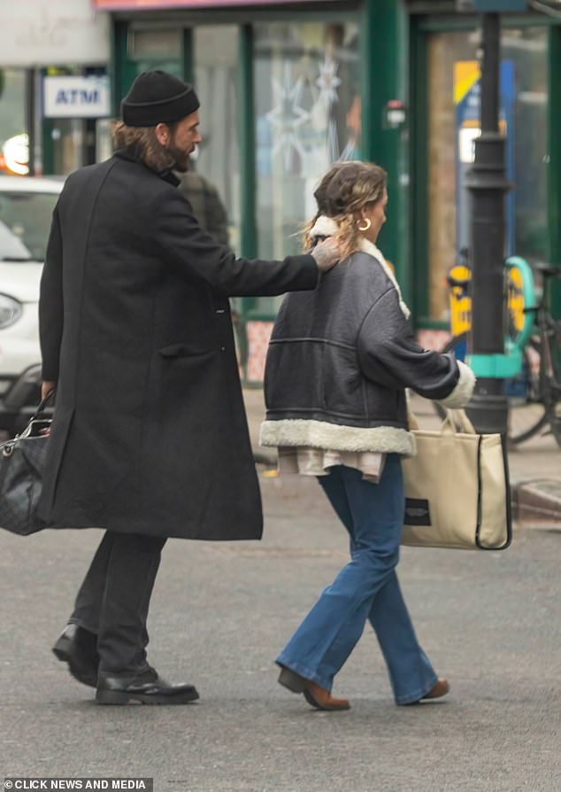 As Pete and Jowita left an office, the television personality placed a protective hand on the dancer's shoulder as they crossed the road