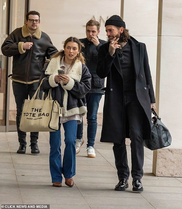 Pete, wearing a black beanie and carrying a Louis Vuitton bag, looked slightly dejected as he puffed on a cigarette