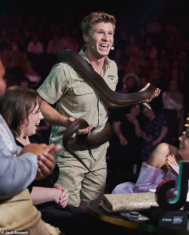 The famed conservationist, who hosted the event at the Hordern Pavillion, left guests looking concerned as he pulled out a huge, non-venomous snake and showed it to the crowd.