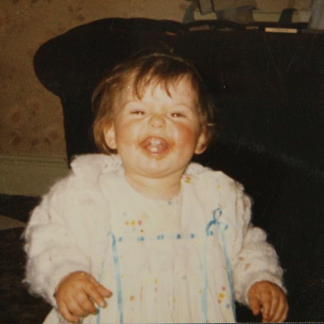 Another cheeky photo showed her covered in food that looked like tomato sauce as a child as she flashed a toothy grin