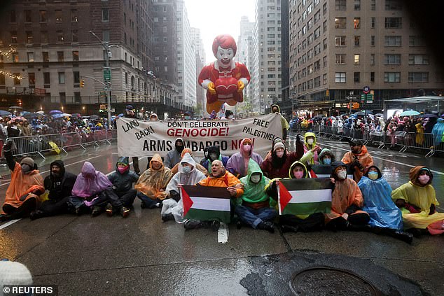 Protesters wearing rain ponchos and holding Palestinian flags tired to disrupt the parade