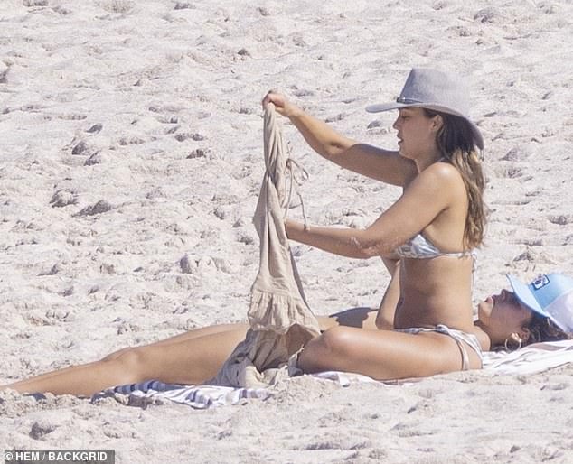 The star revealed her toned midriff as she relaxed on holiday