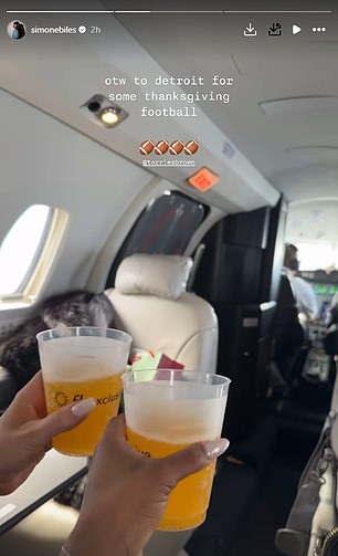 Biles and Torrie Brown clinked their glasses on the plane