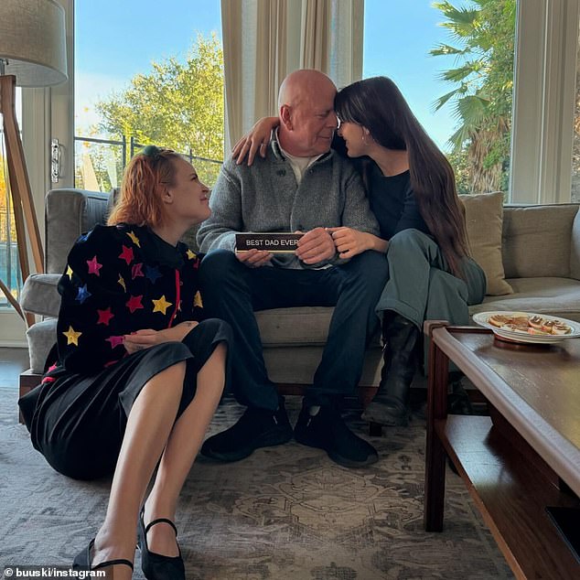 The retired actor, 69, was seen smiling at his daughter Scout, 33, as he sat on a sofa, while daughter Tallulah, 30, looked up at him from the floor.