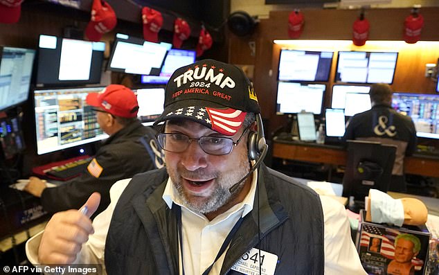 Traders on the New York Stock Exchange wear MAGA hats the day after Trump's re-election