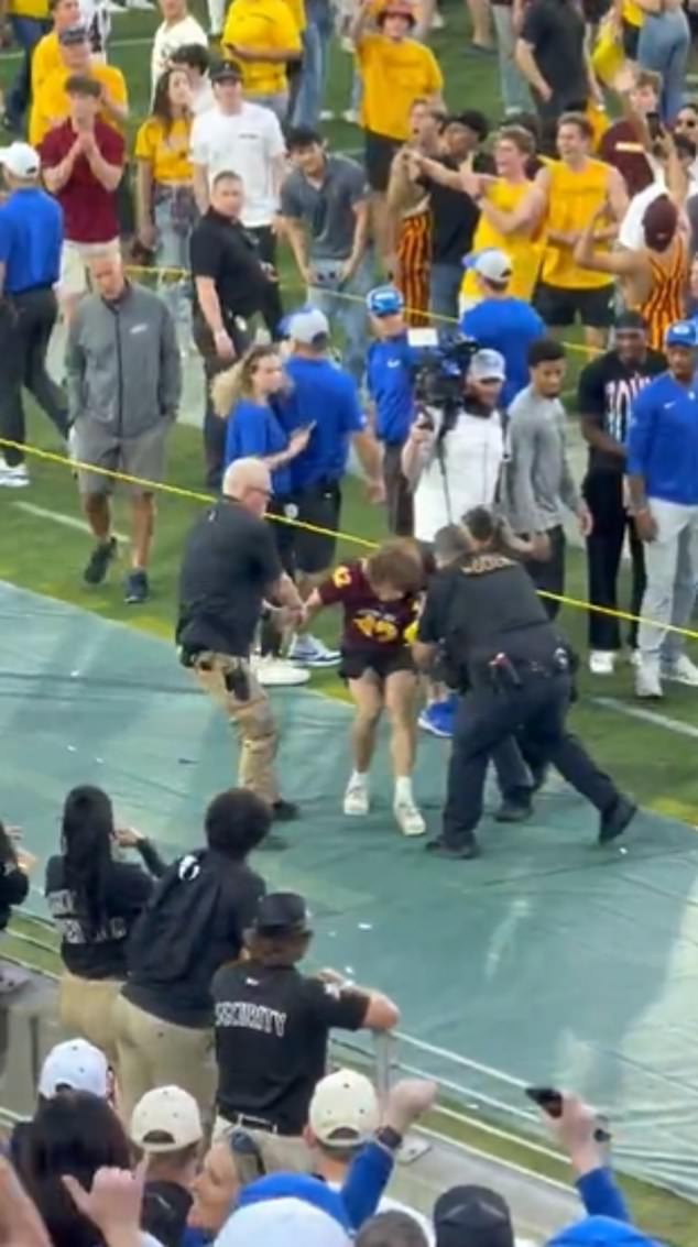 An Arizona State fan was arrested on the sidelines of the stadium after chasing BYU coaches