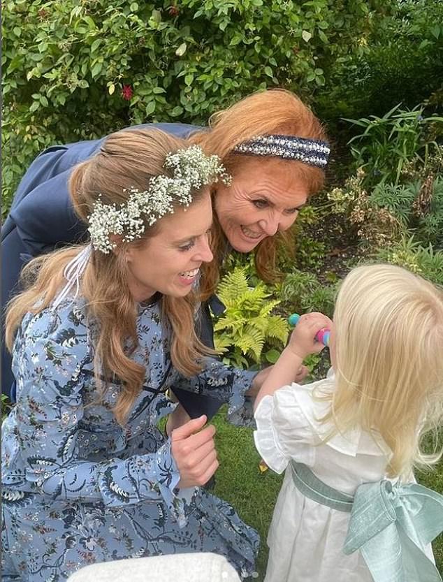 Sarah and Beatrice smile at Sienna, the princesses' daughter