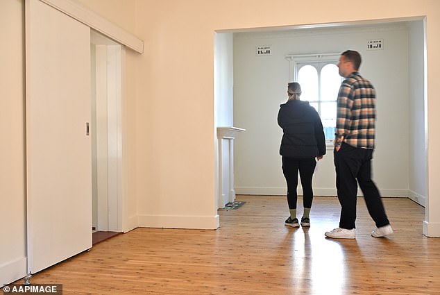 Australian home borrowers have taken another blow just half an hour before the Melbourne Cup as interest rates remained on hold (pictured is a home inspection in Sydney)