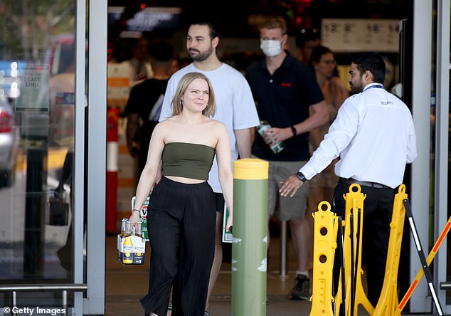 Alcoholic drinks may be in short supply on Australia's east coast over the festive period after workers at distribution centers (pictured, customers at a Dan Murphy's in Adelaide)