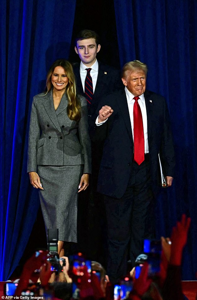 Wearing a black suit and striped tie, he reflected his father's style as he seemed reserved at the back of the pack.