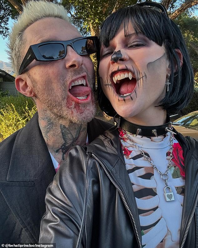 Behati Prinsloo shared a selection of photos from her family Halloween party. Included in the series of images was a cozy photo of herself with her husband Adam Levine, 45