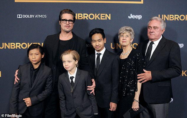 Brad Pitt's (right) parents haven't seen the children he shares with Angelina Jolie in eight years, sources have told DailyMail.com (pictured with Brad, Pax, Shiloh and Maddox in 2014)