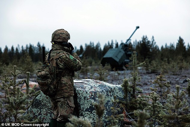 Rifle Line Section Commander Staff Sergeant Rai uses a radio to speak to the Archers crews of the 19th Regiment Royal Artillery NATO live fire exercises in Finland called Exercise Dynamic Front