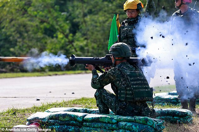 Ready for action: A Taiwanese conscript launches missiles during an exercise at a military base in Tainan, Taiwan