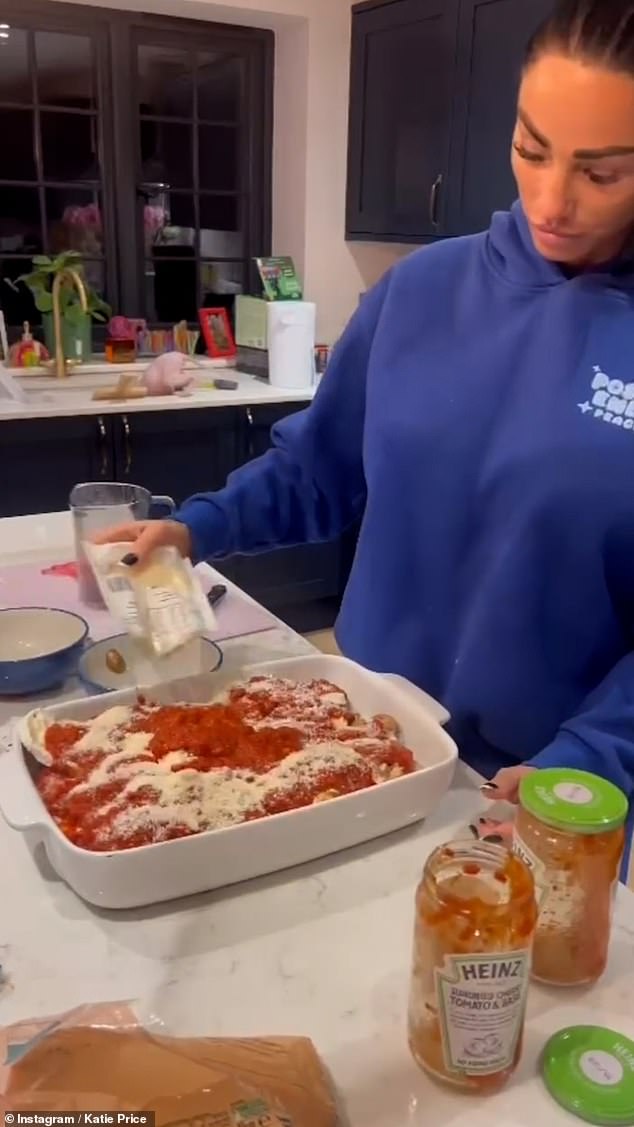 Katie seemed oblivious as she chatted casually to the camera, explaining how she added basil leaves, spaghetti, cheese and tomatoes to the dish before putting it in the oven.