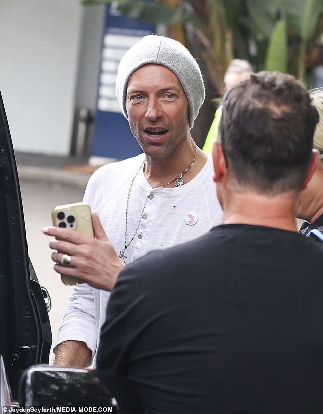 The Coldplay frontman was all smiles as he spoke to fans in an impromptu meet and greet after he arrived