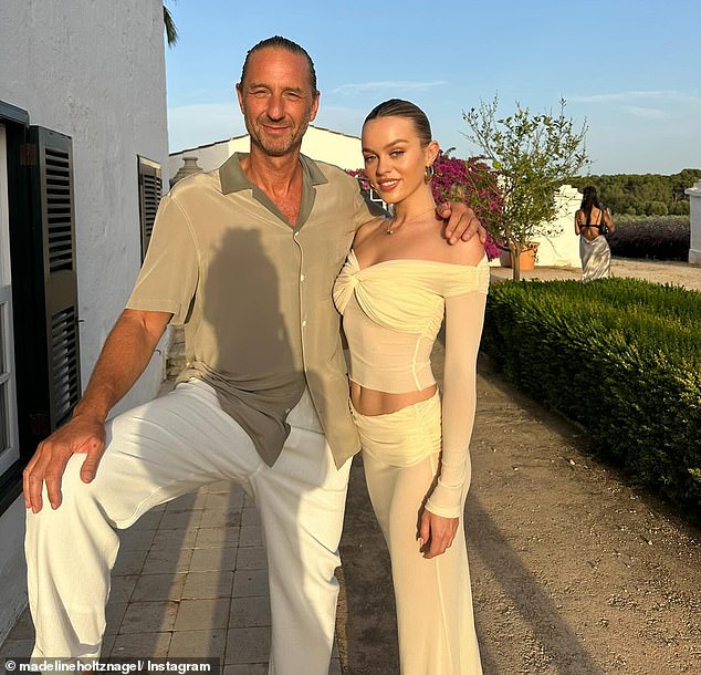 Justin Hemmes, 52, (pictured with his partner Madeline Holtznagel) was allegedly targeted by a man who claimed to be a motorcyclist and said he owed money to the hospitality billionaire