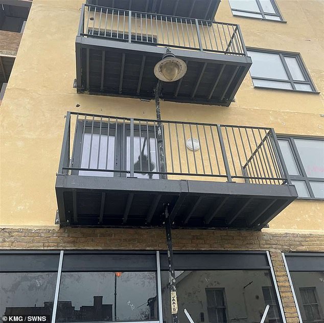 The bizarre sight of Jeffery Street in Gillingham, Kent appeared outside the four-storey block where the project's balcony is built around a lamppost