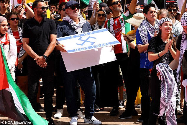 Mr Yazbek (pictured holding a sign) was arrested on October 6 for displaying a Nazi symbol at a pro-Palestine protest in Sydney. He will be sentenced on December 10