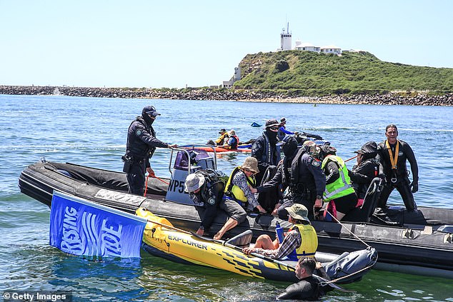 Officers on inflatable police boats and jet skis were seen towing protesters into police vessels