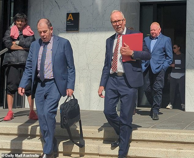 A shattered Mick Murphy (far right) leaves the Ballarat Magistrates' Court behind the police and prosecutor