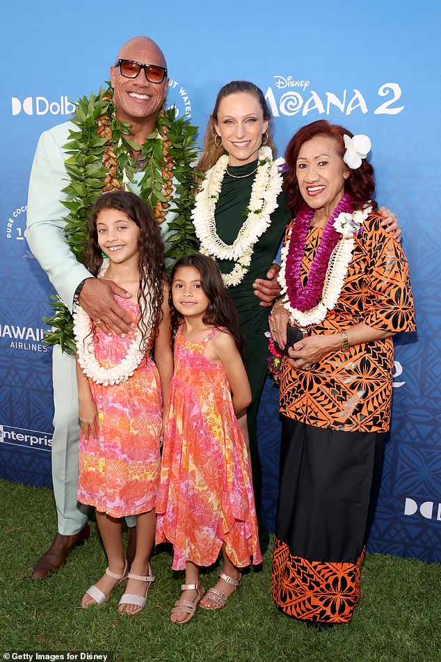 Dwayne 'The Rock' Johnson posed for a rare family photo as he attended the world premiere of Moana 2 in Hawaii on Thursday - photo of wife Lauren Hashian, daughters Jasmine, eight, and Tiana, six, and mother Ata Johnson, 76