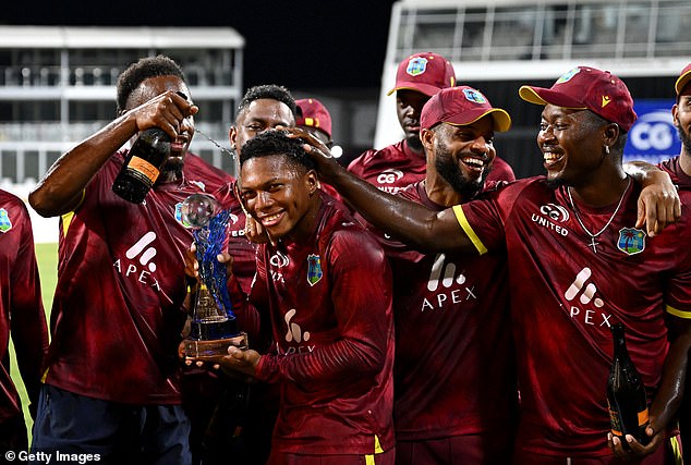 The West Indies players celebrate with the series trophy after beating England again