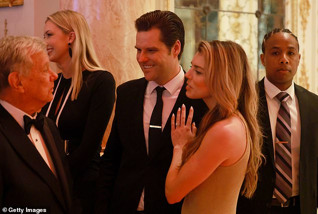 Former U.S. Rep. Matt Gaetz (C) and wife Ginger Luckey Gaetz talk with another guest at the America First Policy Institute Gala held at Mar-a-Lago on Nov. 14, 2024 in Palm Beach.