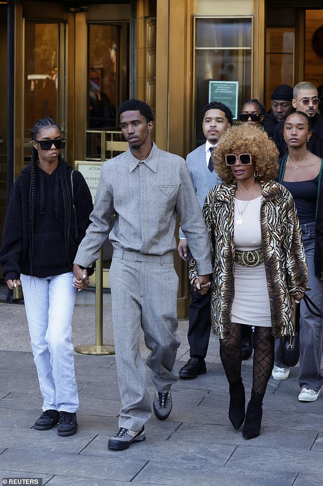 Janice Combs, far right, walks out of a federal courthouse in Manhattan with her grandchildren.