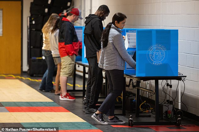 Democracy and the economy are the two most important issues for voters in what could be one of the closest elections in history, exit polls show. Georgia residents cast their votes on Election Day above