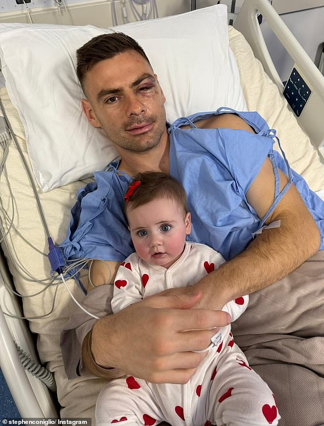 GWS Giants veteran Stephen Coniglio is pictured with his daughter Amira after undergoing surgery for a serious facial injury