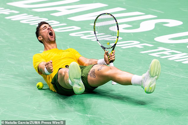 Thanasi Kokkinakis is pictured collapsing on the court as he celebrates his thrilling victory over American Ben Shelton after saving four match points in a tiebreak