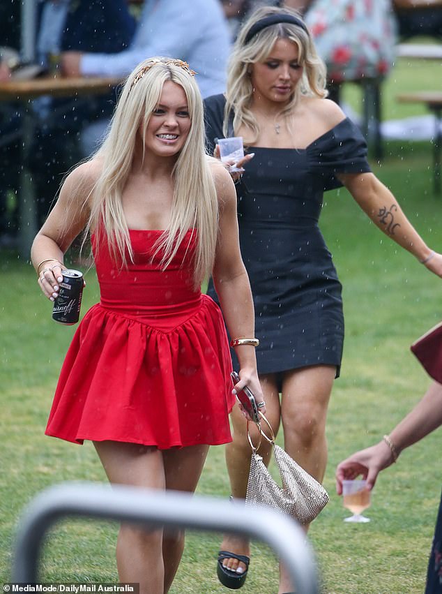 Crown Oaks Ladies Day attendees took cover as the heavens opened