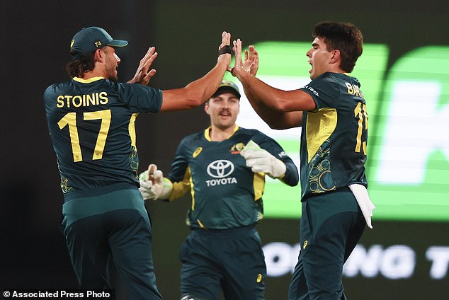 Australian Xavier Bartlett, right, is congratulated by teammate Marcus Stoinis, left, after dismissing Pakistan's Mohammad Rizwan during the T20 cricket international between Pakistan and Australia at the Gabba in Brisbane, Australia, Thursday, November 14, 2024. (AP Photo/Tertius Pickard)