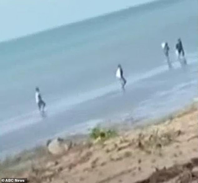 The four men were spotted walking on the beach (pictured) on Croker Island, near the Coburg Peninsula in the Northern Territory, on Monday.