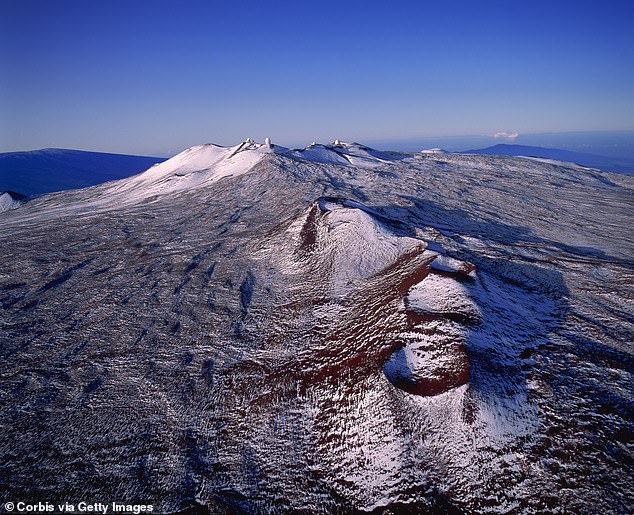 Mauna Kea, Hawaii's highest peak, is covered in snow after the tropical hotspot was hit by a rare cold snap