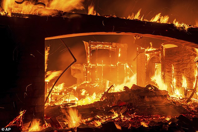 Flames consume a house as the Mountain Fire burns in Camarillo, California in November 2024