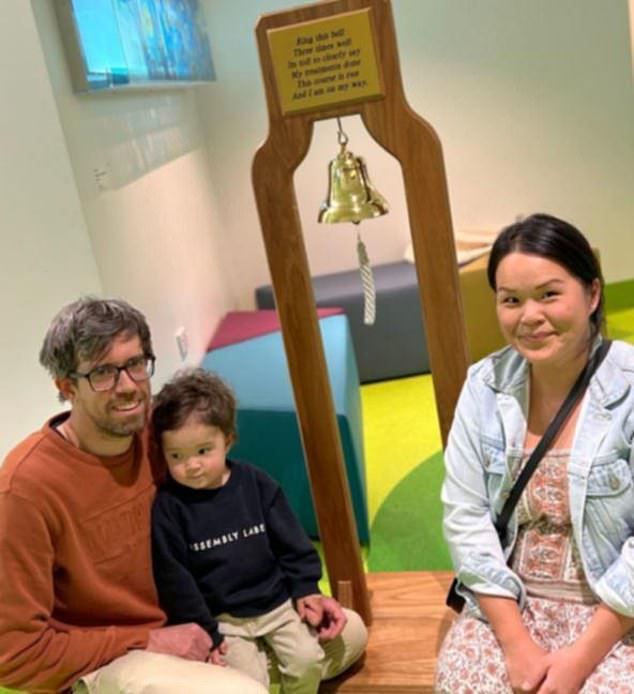 Pictured from L-R are Jeff, Luca and Diana Kitson with the end of treatment bell. The four-year-old was diagnosed with neuroblastoma, a rare form of cancer, just before his second birthday