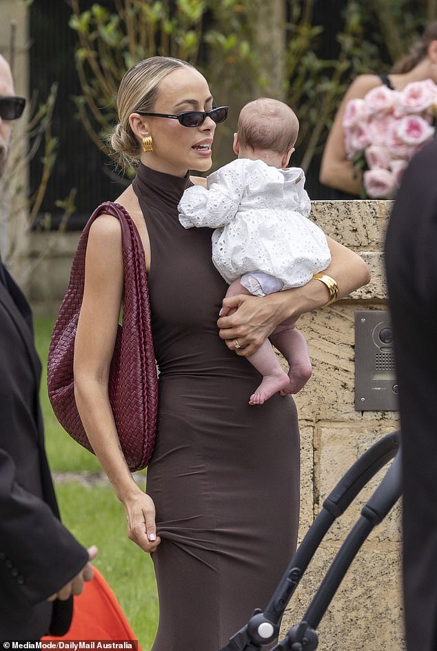 Em Davies (pictured) appeared to break Tammy Hembrow's strict ban on children as she attended her star-studded wedding ceremony in Byron Bay on Saturday