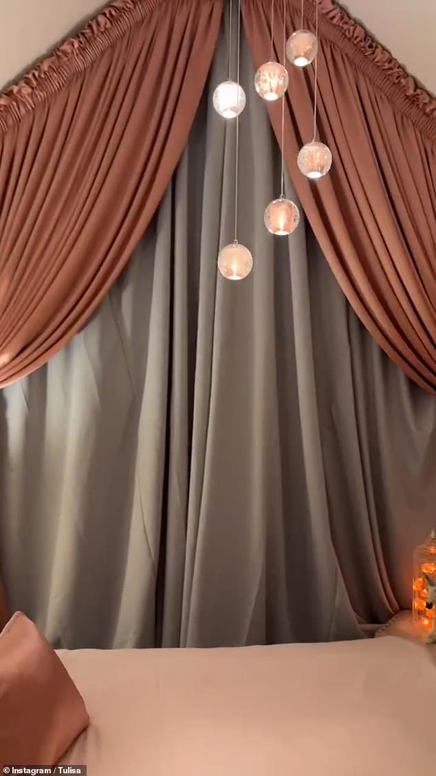 A pink glass chandelier hung from the ceiling, lighting up the room