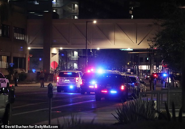 Flashing blue lights illuminated the dark streets of downtown Phoenix. Police cordoned off parts of the road while a drone hovered high above. Police have been scouring the scene and investigating a bomb threat in the heart of Arizona.