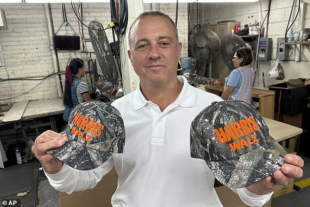 Unionwear owner Mitch Cahn holds two of the 5,000 Harris Walz hats made for the campaign every day at his 70,000-square-foot factory in Newark, New Jersey, on Tuesday, October 22, 2024