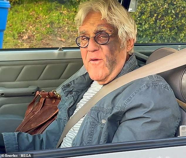 Jay Leno has sparked a wild conspiracy theory after suffering a 60-foot fall down a hill that left him with significant bruising to the left side of his face, an eye patch and a broken wrist (seen Wednesday)