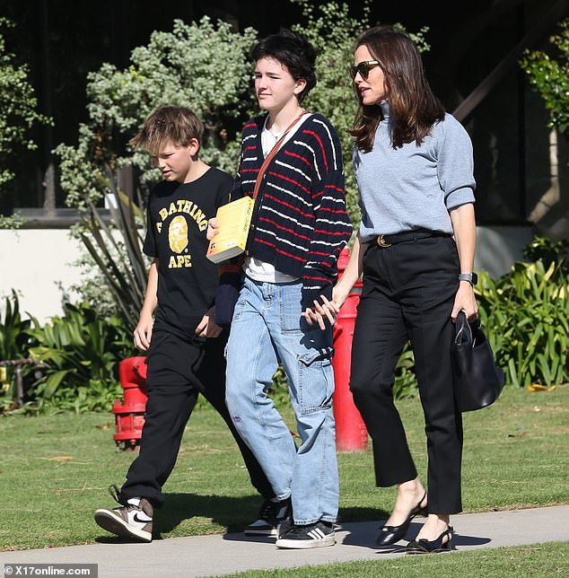 Jennifer Garner, 52, and her child Fin, 15, showed how close they are during Sunday's family visit with Jennifer's youngest child, 12-year-old Samuel (L)