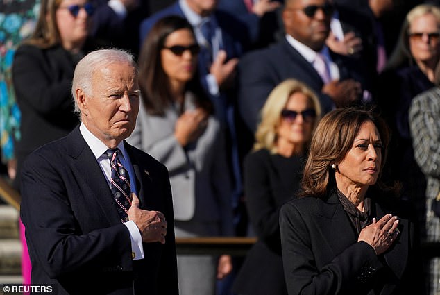 Jill Biden stands behind President Joe Biden and Vice President Kamala Harris during the Veterans Day wreath laying ceremony at Arlington National Cemetery